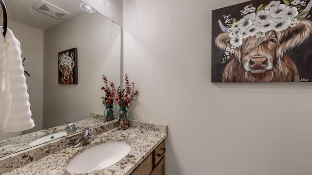 bathroom with vanity and visible vents