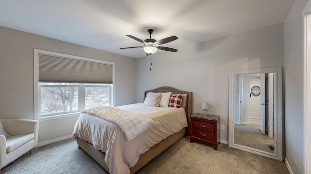 bedroom featuring ceiling fan, baseboards, and light carpet