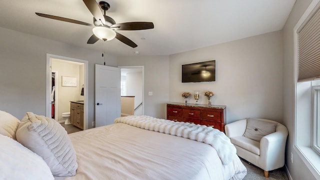 bedroom with ensuite bath and ceiling fan