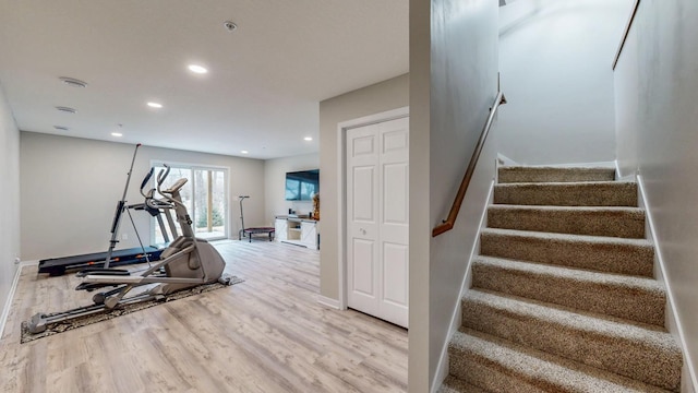 exercise area featuring recessed lighting, baseboards, and wood finished floors