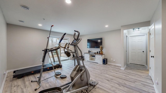 workout room with recessed lighting, baseboards, and light wood finished floors