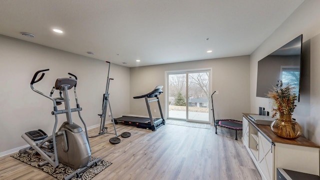 workout room with recessed lighting, light wood-type flooring, and baseboards