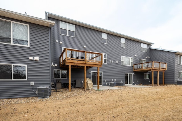 rear view of property featuring a patio area and central AC