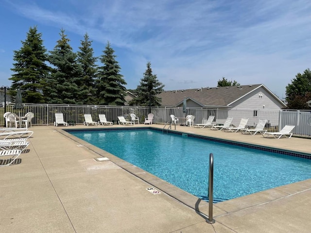 pool featuring a patio area and fence