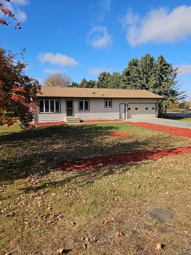 ranch-style house with entry steps, driveway, an attached garage, and a front yard