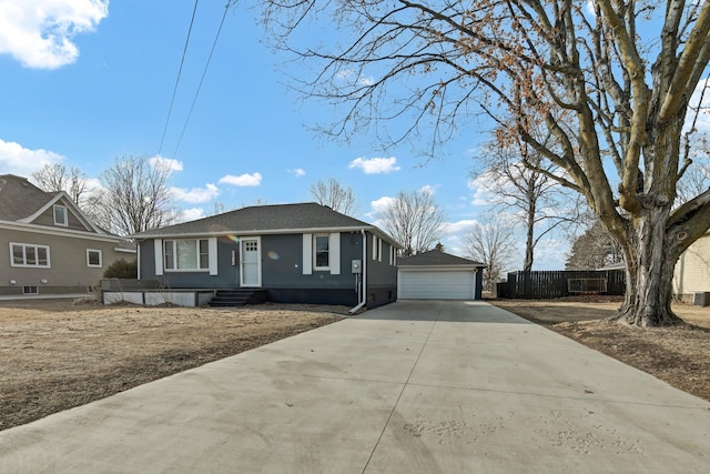 view of front of house featuring an outbuilding, fence, a garage, and stucco siding