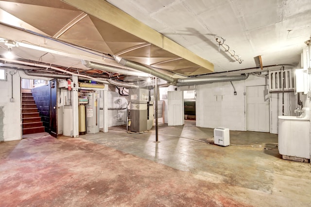 basement featuring stairs, washer / clothes dryer, electric water heater, and heating unit