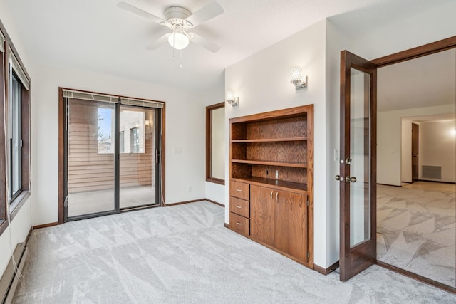 unfurnished bedroom with access to outside, light colored carpet, and visible vents