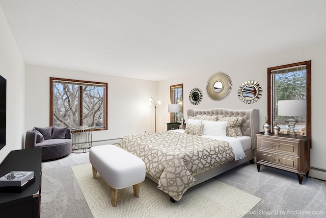 bedroom with baseboard heating and carpet