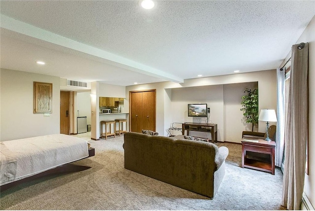 living area featuring visible vents, beam ceiling, light colored carpet, and a textured ceiling