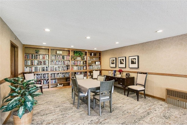 dining area featuring a textured ceiling, recessed lighting, carpet floors, wainscoting, and wallpapered walls