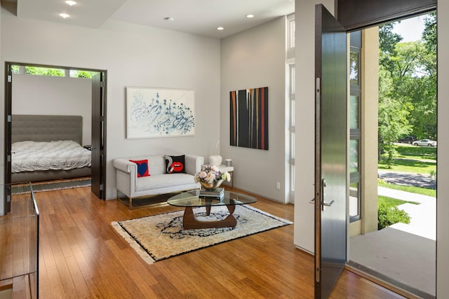 living area with hardwood / wood-style floors and recessed lighting