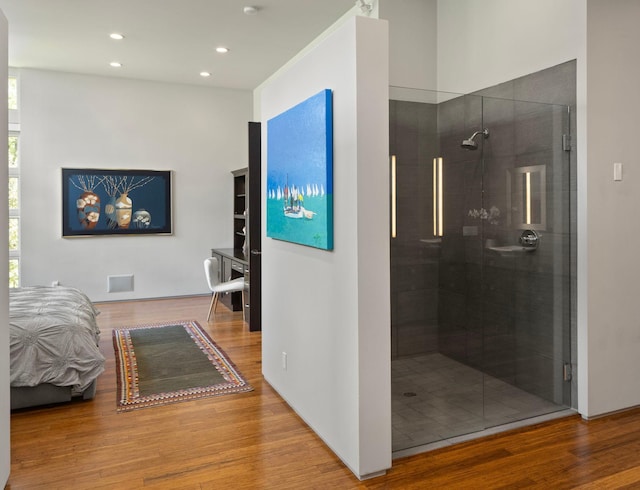 interior space with a shower stall, visible vents, wood finished floors, and recessed lighting