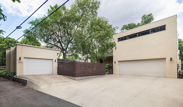 view of front of property with a garage and stucco siding