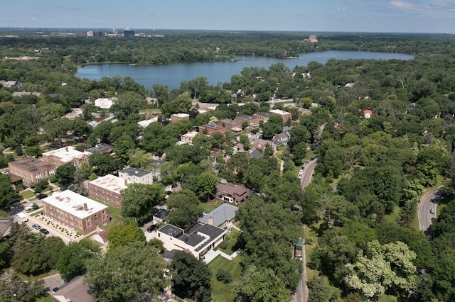 drone / aerial view featuring a water view and a view of trees