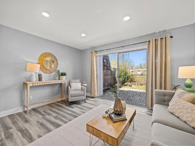 living area featuring recessed lighting, baseboards, and wood finished floors