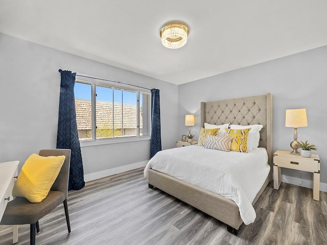 bedroom featuring baseboards and wood finished floors