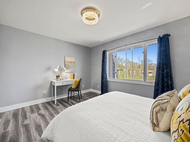 bedroom featuring baseboards and wood finished floors