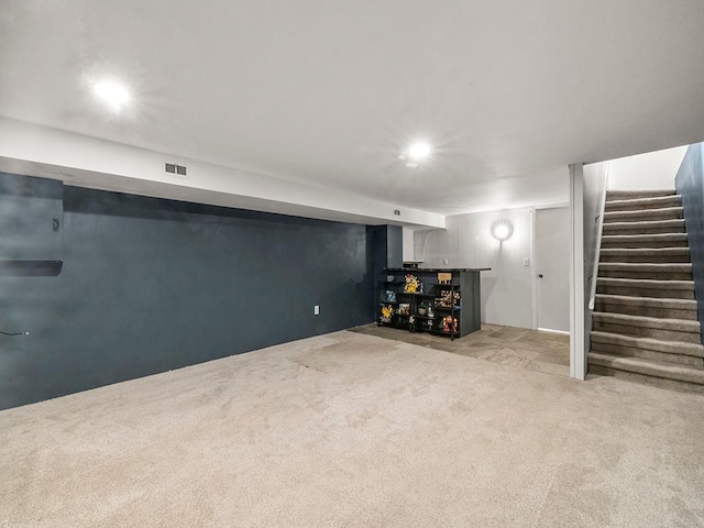 finished basement with bar, carpet floors, recessed lighting, visible vents, and stairway