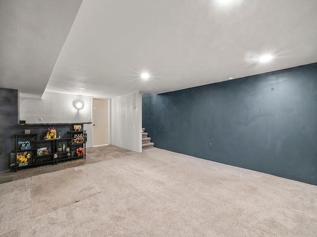 finished below grade area with stairway, carpet floors, and recessed lighting