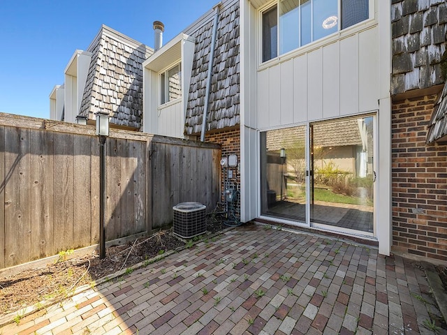 view of patio with fence and central AC unit