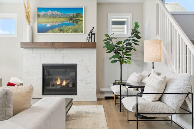 living area with a fireplace and wood finished floors