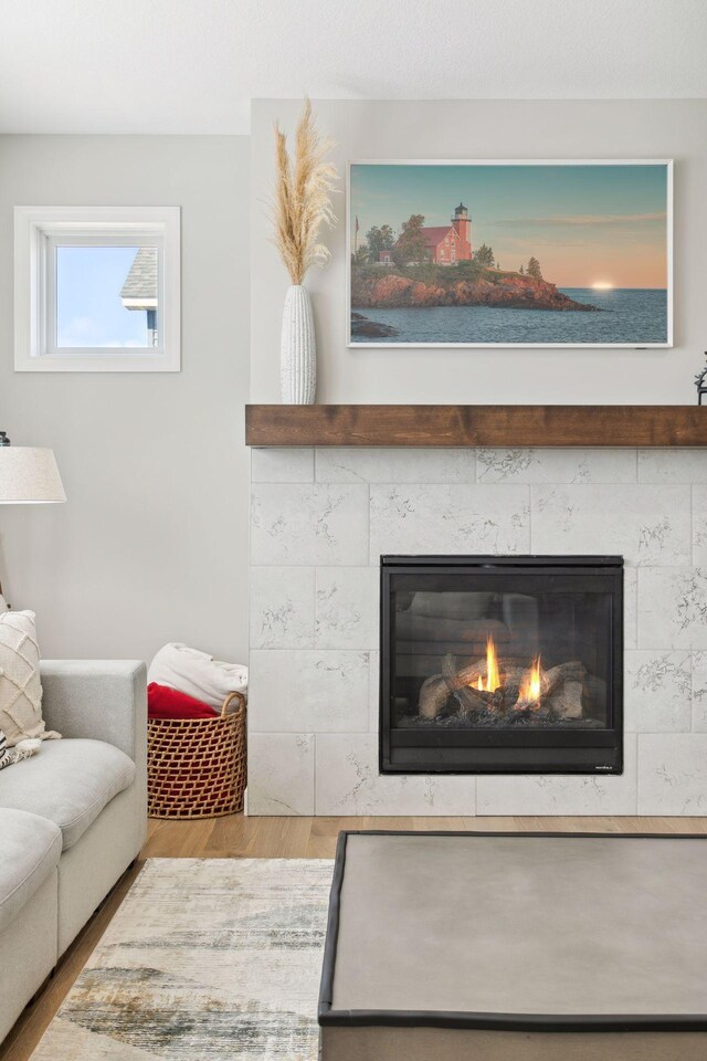 living room featuring wood finished floors and a tile fireplace