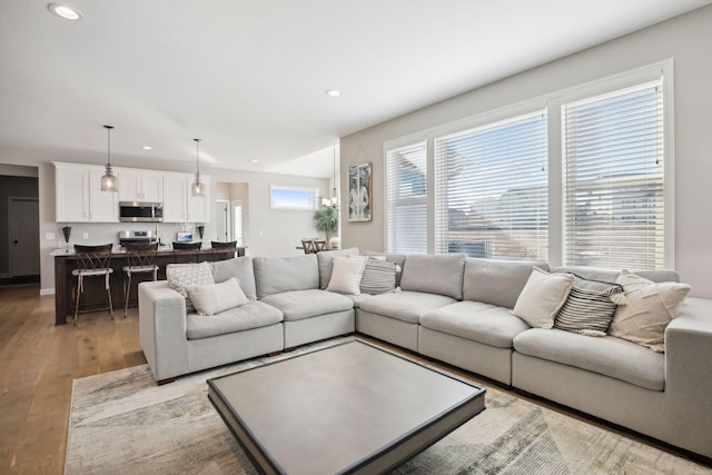 living area featuring light wood-style floors and recessed lighting