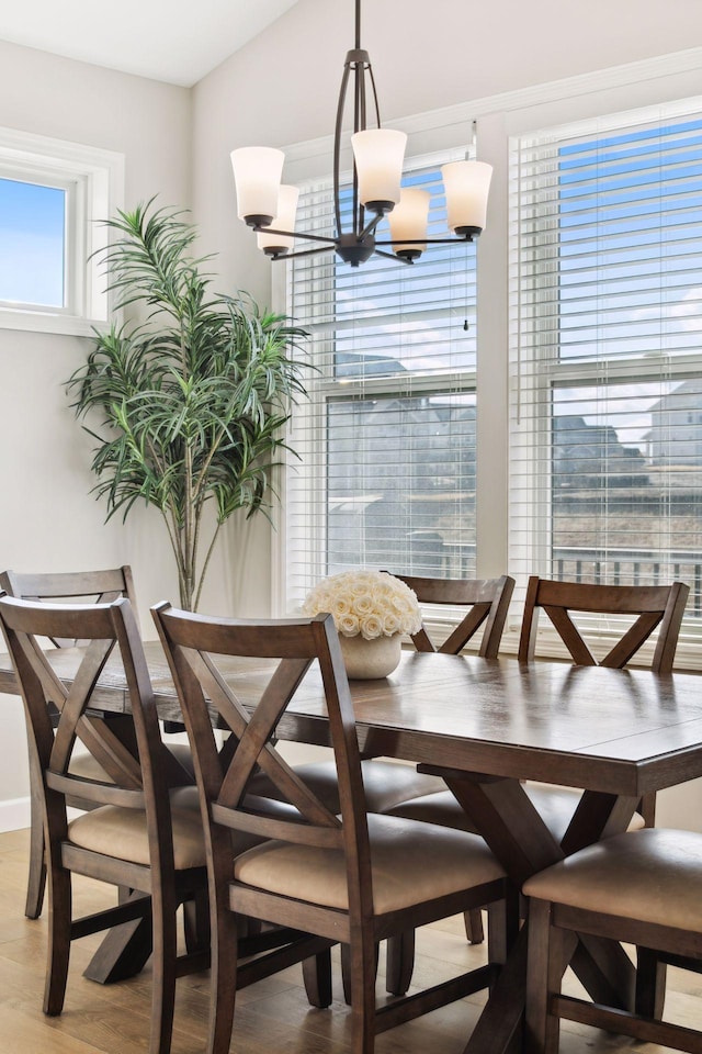 dining room with an inviting chandelier and light wood-style flooring