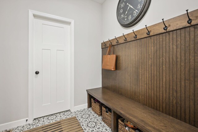 mudroom with baseboards and tile patterned floors