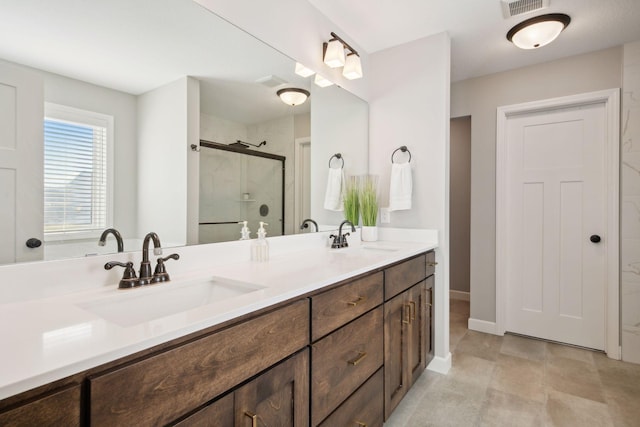 full bathroom featuring double vanity, a stall shower, a sink, and visible vents