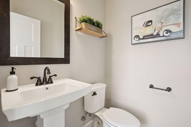 half bath with a sink and toilet