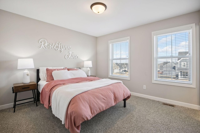 bedroom with carpet, visible vents, and baseboards