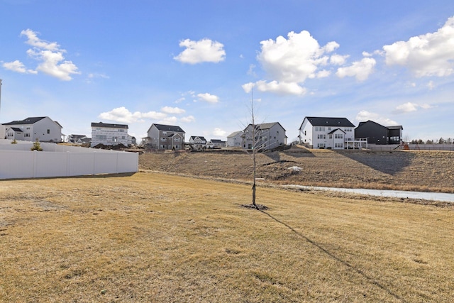 view of yard featuring a residential view and fence