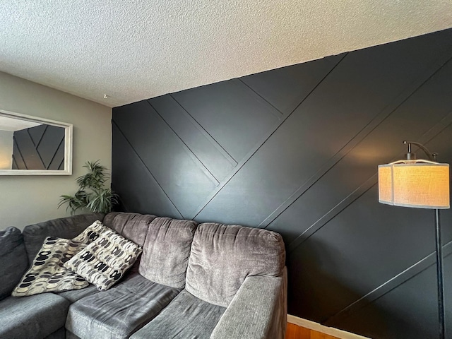 living area featuring a textured ceiling