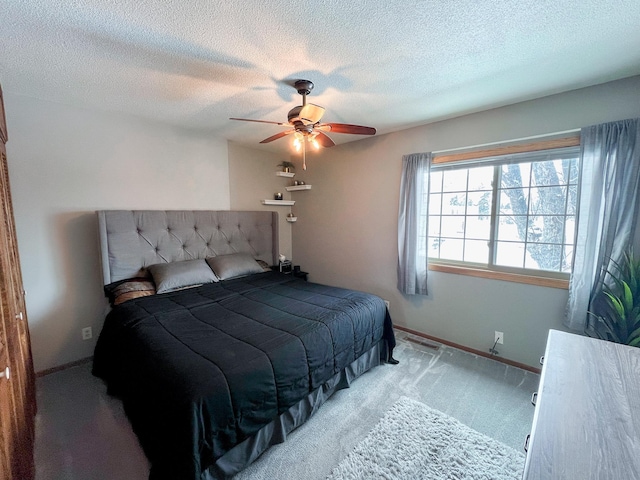 bedroom with baseboards, carpet, a ceiling fan, and a textured ceiling