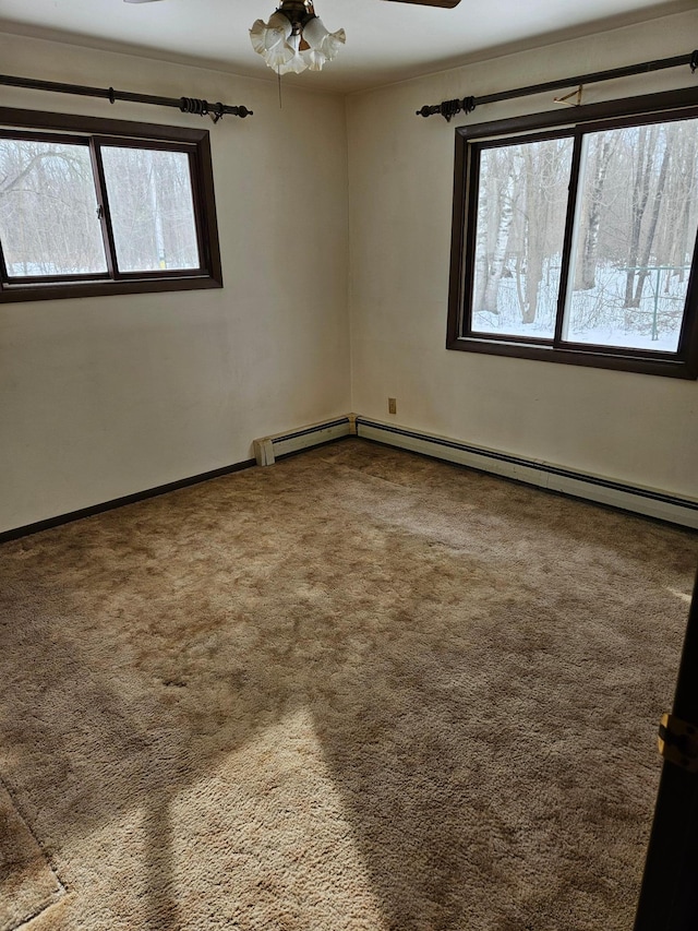 unfurnished room with carpet flooring, plenty of natural light, baseboards, and a ceiling fan