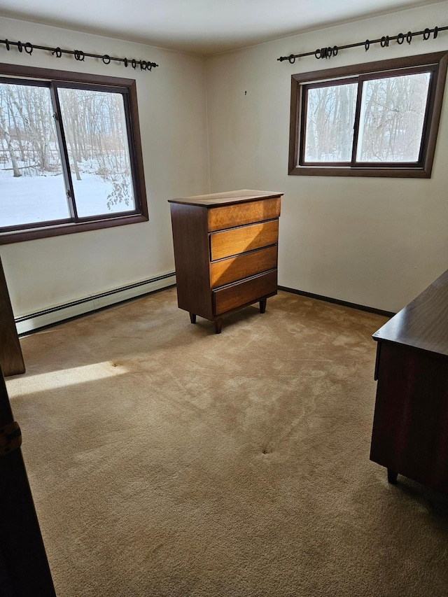 unfurnished bedroom with baseboards, carpet floors, and a baseboard radiator