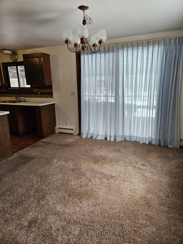 kitchen featuring a chandelier, carpet flooring, baseboard heating, and a sink