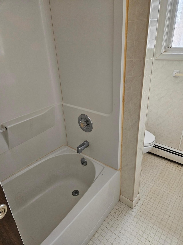 full bathroom with tile patterned floors, a baseboard radiator, toilet, and bathtub / shower combination