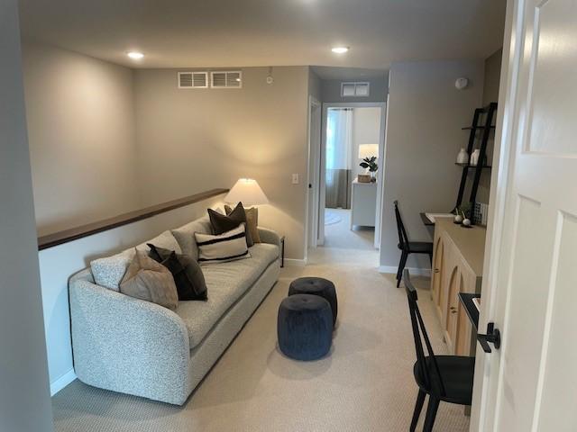 living room with recessed lighting, carpet, visible vents, and baseboards