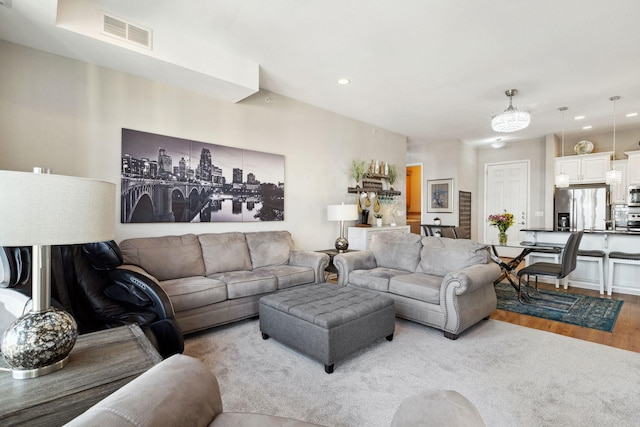 living area featuring visible vents, recessed lighting, and light wood-style flooring