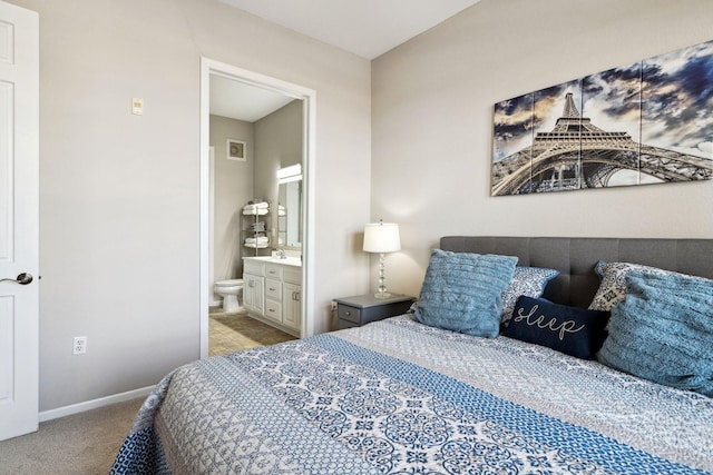 carpeted bedroom featuring baseboards and ensuite bath