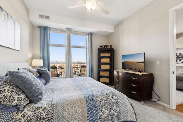 bedroom featuring visible vents, baseboards, light carpet, and ceiling fan