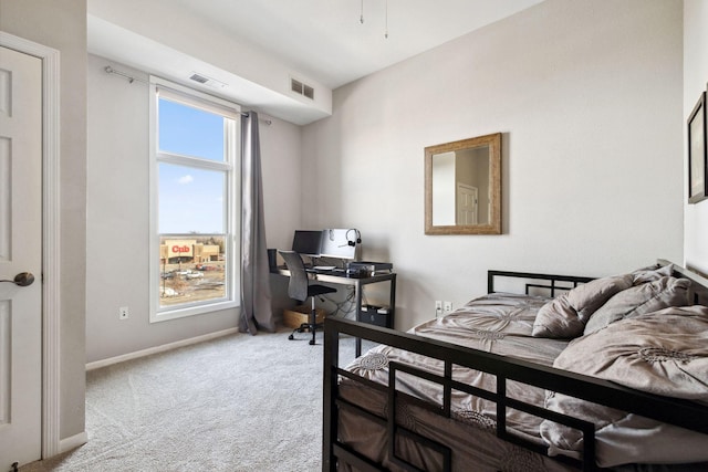 carpeted bedroom featuring visible vents and baseboards