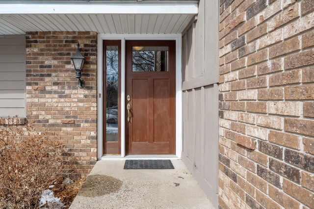 doorway to property with brick siding