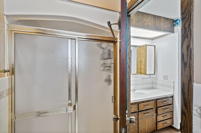 full bathroom featuring vanity and a shower stall