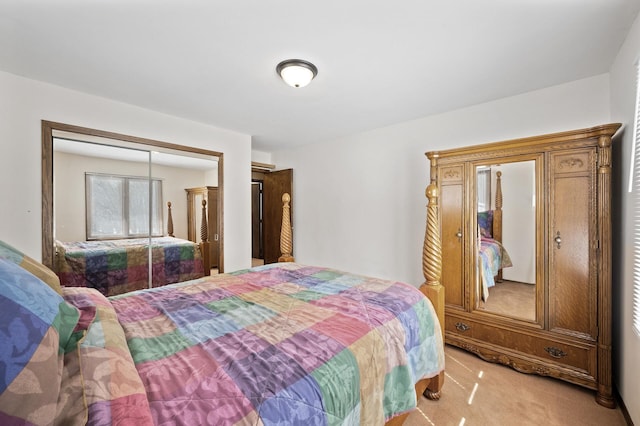 bedroom with light colored carpet and a closet