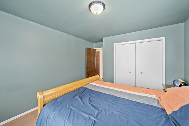 bedroom with baseboards and a closet