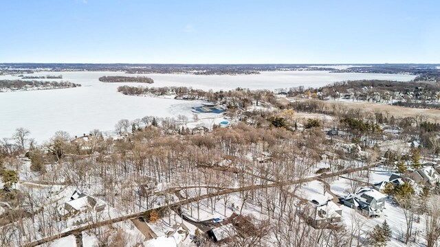 snowy aerial view with a water view